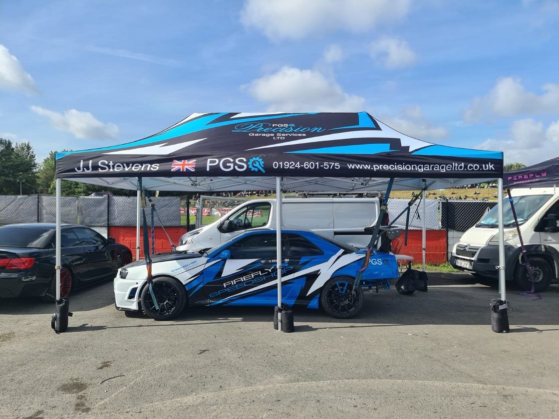 A gazebo tent with a roof printed like the vehicle beneath it