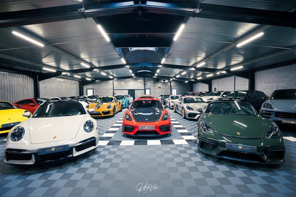 A luxury car collection with swisstrax modular flooring on the ground