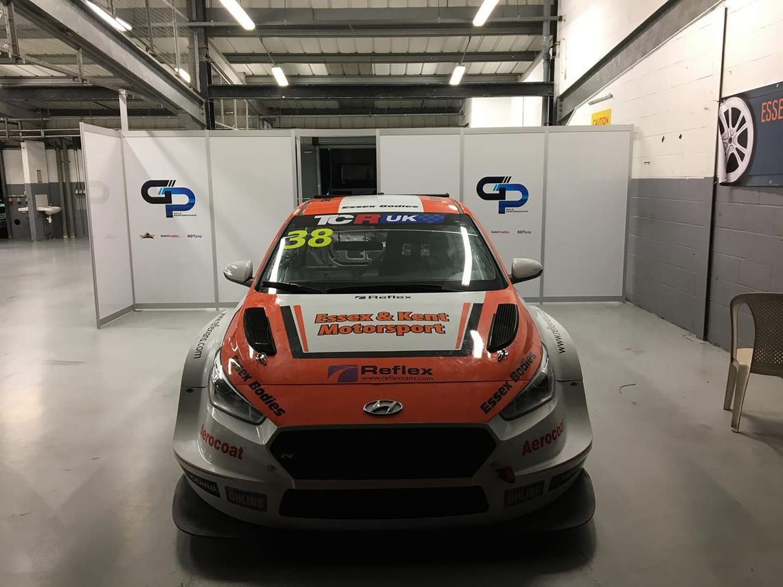 A TCR car in front of some traditional pit walling